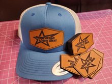 Load image into Gallery viewer, Blue cap with leather patch logo and matching stickers on a pink cutting mat
